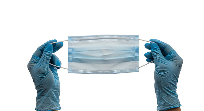 Two hands in blue nitrile gloves carefully holding a light blue surgical face mask. 