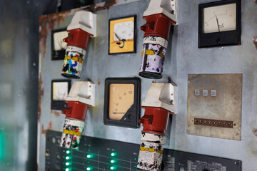A row of four electrical meters are covered in paint