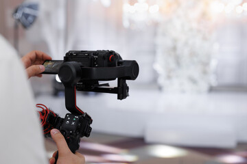 Professional videographer's camera for wedding photography.