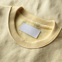 White blank laundry care clothes label on shirt fabric background 