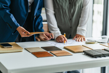 Consultant reviewing wood laminate samples for interior project