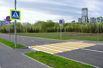 Pedestrian crossing and road signs in an urban environment