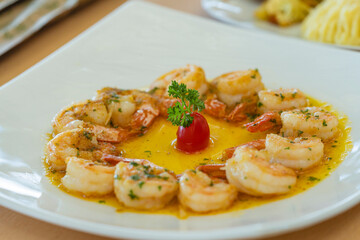 Shrimp in garlic butter sauce with cherry tomato and parsley