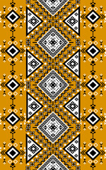 A vibrant geometric tribal pattern featuring black and white diamond shapes on a mustard yellow background, creating a bold and intricate design.