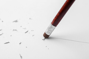 Graphite pencil with eraser on paper sheet, closeup