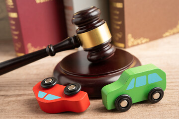 Car accident lawsuit and insurance, Judge hammer with car model.