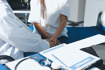 The doctor is checking and encouraging the patient.