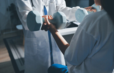 Unrecognizable uses blue hand weight during physical therapy session