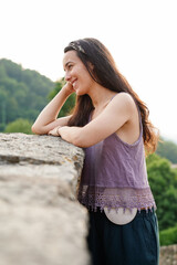 Smiling young woman with ostomy bag in the mountains