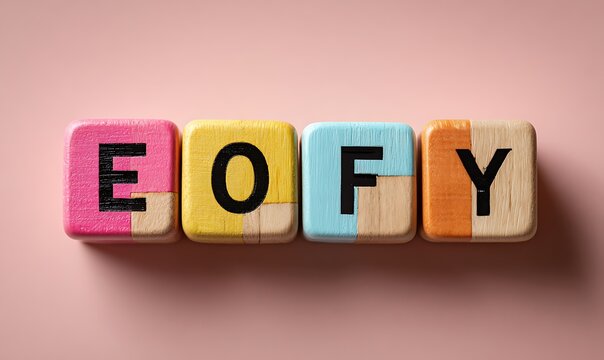 Colorful Wooden EOFY Cubes And Black Floory Letters On Pink Pastel Background
