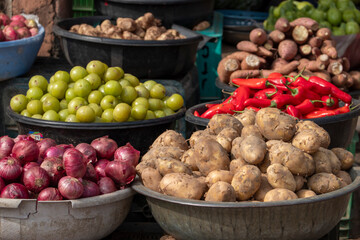 A vegetable market in Delhi with piles of fresh vegetables and fruit for sale