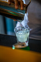 Bartender mixing drinks, pouring mixed, alcohol, liquor ingredient, preparation, female hands,...