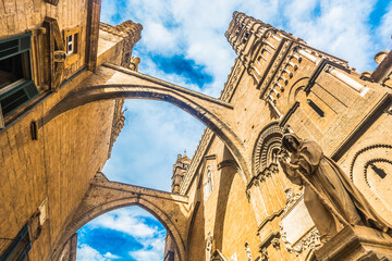 Close-up view of the architectural details of Palermo Cathedral towers and connecting bridge elements, showcasing its harmonious blend of Norman, Gothic, and Arab styles