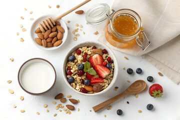 Top-down photo of a healthy breakfast with muesli, honey jar, and glass of milk. All food objects are placed ONLY in the bottom right corner of the image. The ENTIRE center and left side must be PURE 