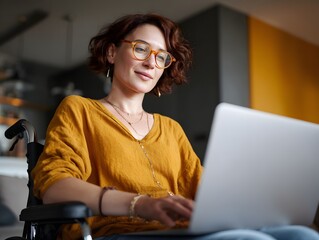 remote worker in a wheelchair using a laptop at a home office