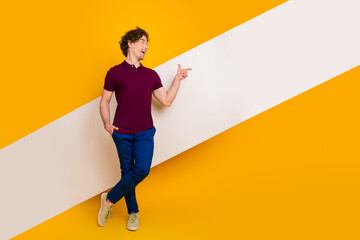 Young male in casual attire posing stylishly against a yellow background showcasing confidence and...