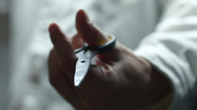 Barber holding sharp scissors on white background.
Using sharp scissors to cut something.
Scissors, cut, blade, hair