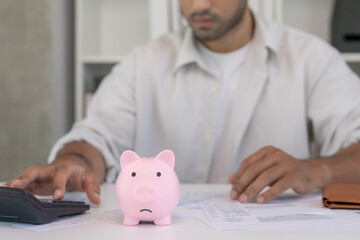Stressed and headache man with large bills or invoices no money to pay to expenses and credit card...