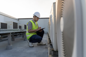 Asian maintenance engineer works on the roof of factory. contractor inspect compressor system and plans installation of air condition systems in construction. Checklist, inspector, control