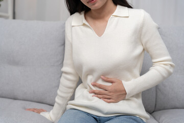 stomach ache. Asian women have abdominal pain, indigestion, gastritis, menstrual cramps,...