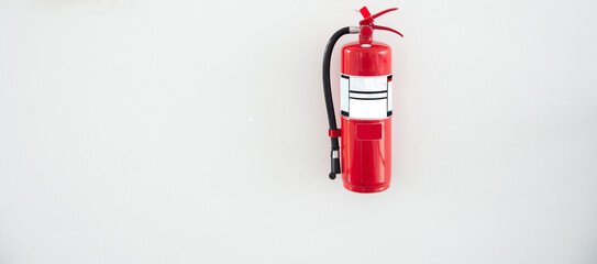 Red fire extinguisher attached to concrete wall, for fire extinguishing mission, fire prevention...