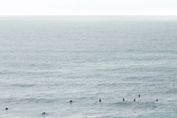 Surfers Riding Waves Along the Portuguese Coastline