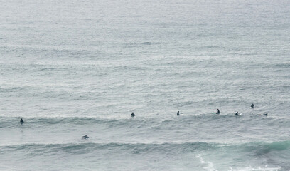 Surfers Riding Waves Along the Portuguese Coastline