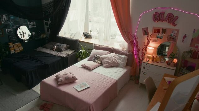 High angle no people shot of spilt interior with dark, gothic side and pink-themed feminine side