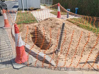 Excavation area courdin by safety cones or safety warning tape. Interlock area are excavated with...