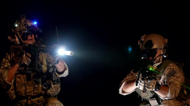 special forces soldiers conduct a night raid using night vision goggles a tactical light and a laser sight A concept for modern warfare and covert operations