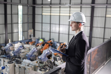 Confident manager overseeing robotic operations in a modern industrial facility