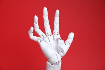One white mannequin hand on red background