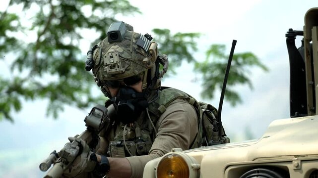 A special forces soldier equipped with a gas mask and advanced combat helmet stands guard by an armored vehicle A concept for CBRN defense and modern warfare readiness