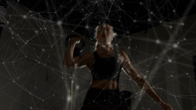 Fit athlete entering studio lifting kettlebell, swinging overhead pressing, network overlay pulsing