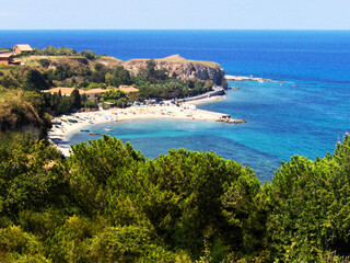 Panoramic distant view of a beautiful blue beach in Calabria, Italy, where the vibrant shades of...