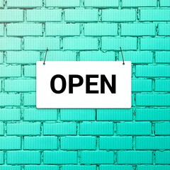 Fototapeta premium Red no parking sign illustration on a blue brick wall, a common street concept near a London hospital building