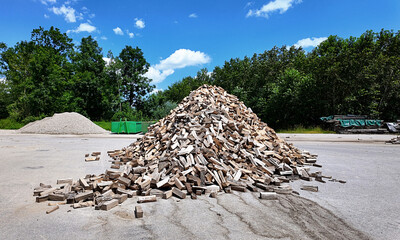 open air joinery in woodland:  mound of sliced pieces of tree trunks for kindling
