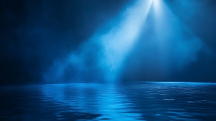 Obraz premium Blue spotlight illuminating smoky, reflective surface.