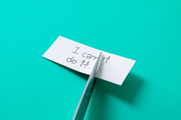 To cutting paper note with scissors to remove T word from I can't do it .
