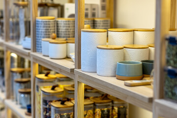 Shelves with glass and ceramic tableware in the gift department of a shopping center
