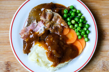 Classic Liver and Bacon With Mash Potatoes Peas Carrots and Onion Gravy
