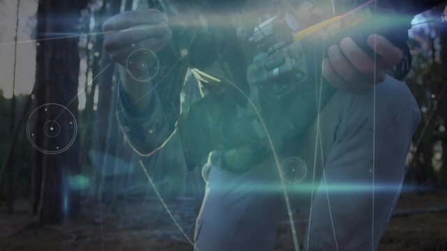 Man spotting yellow-fletched bolt among pine needles and loading compound crossbow for hunting