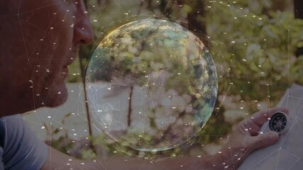 On globe with network nodes appearing, man picking compass, aligning needle on map for navigation - Powered by Adobe