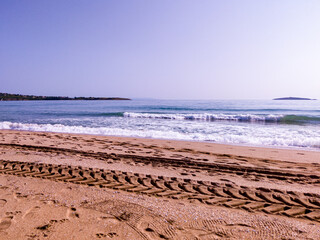 Beach, sea, empty sky and island in the distance