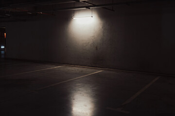 Empty parking lot with overhead dim light