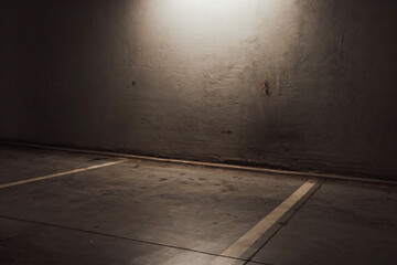 Empty parking lot with overhead dim light