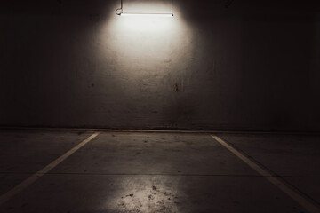 Empty parking lot with overhead dim light