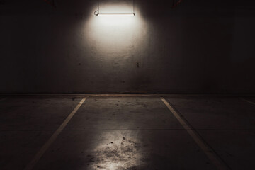 Empty parking lot with overhead dim light