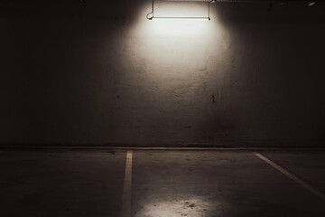 Empty parking lot with overhead dim light