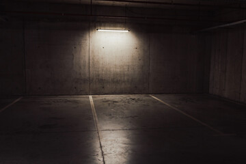 Empty parking lot with overhead dim light